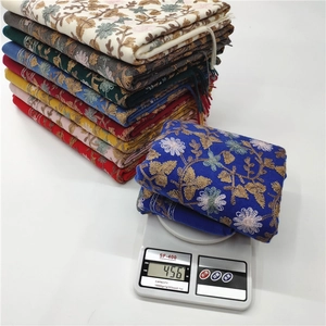 Close-up of thick cashmere-like scarves weighing 456g on a digital scale for warmth