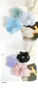 Detailed view of sheer polka dot organza hair scrunchies in various pastel colors