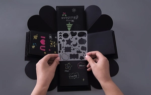 DIY surprise box stencil showing hand drawing on a black hexagonal craft photo album