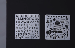 DIY scrapbooking stencil set featuring birthday themes, letters and numbers in white