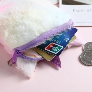 Rainbow unicorn plush coin purse with glitter ears and purple zipper on pink background