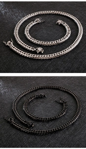 Detail of 18K gold-plated stainless steel dragon head clasp and cuban chain in silver and black