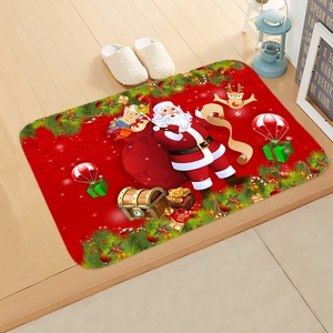 Close-up of a festive red Christmas bath mat with Santa Claus on wooden floor