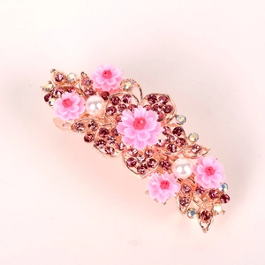 Detail of pink resin flower hair clip with purple rhinestones and white pearls