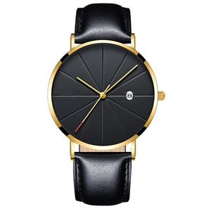 Detail view of quartz watch with black textured dial, golden case and black leather strap