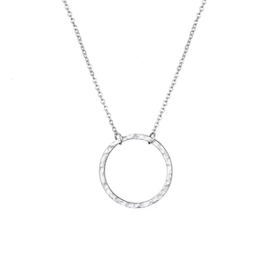 Detail of silver hammered texture circular hollow pendant on a delicate chain necklace