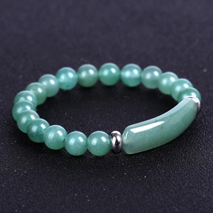 Macro shot of green aventurine beads and rectangular stone on a beaded bracelet