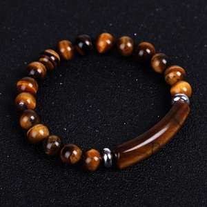 Macro shot of tiger eye stone bracelet with golden brown beads and metallic spacers