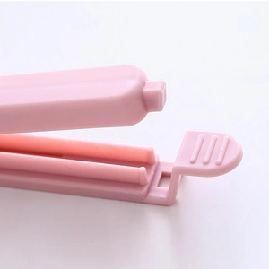Pink plastic snack bag sealer clip for food storage shown on a clean white background