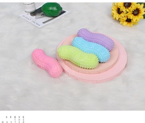 Macro detail of textured rubber peanut dog toys showing non-slip paw patterns