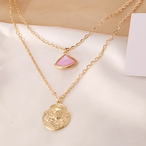 Detail of double-layer gold necklace with pink fan charm and portrait coin pendant