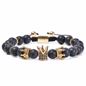 Volcanic lava stone bracelet with golden crown beads for men and women on white background