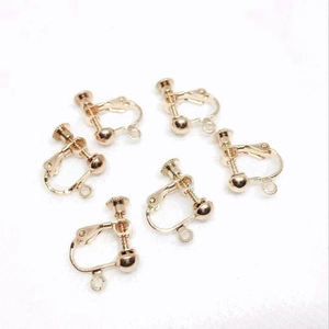 Macro detail of six gold adjustable screw clip-on earring converters for DIY jewelry