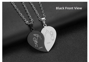 Macro shot of interlocking black and silver heart pendant with Love You engraving