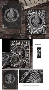 Macro detail of vintage embossed leather notebook featuring silver native feather crown