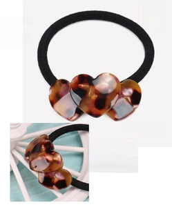 Detail of tortoise shell heart hair tie made of premium French acetate material