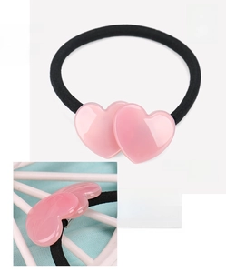 Detail of pink double heart hair tie made from acetate with a glossy polished finish