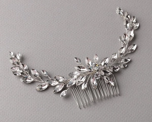 Detail of silver bridal hair comb featuring marquise crystals and vine leaf patterns