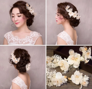 Close-up of handmade white flower hair comb and hair pins for bridal wedding styling