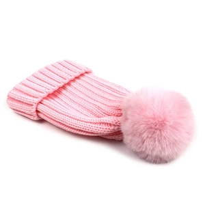 Pink ribbed knit beanie with a fluffy pom pom for women and kids on white background