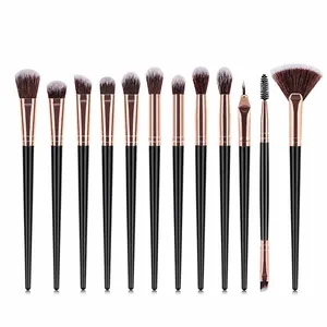 Detailed overhead view of 12 professional makeup brushes with rose gold ferrules