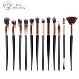 Detailed overhead view of 12 professional makeup brushes with rose gold ferrules