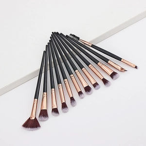 Detail of 12pcs makeup brush set with black handles and rose gold ferrules on white