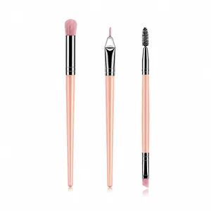 Detailed view of three pink makeup brushes including a double-ended brow brush and liners
