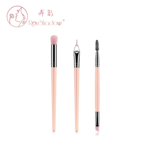 Detailed view of three pink makeup brushes including a double-ended brow brush and liners