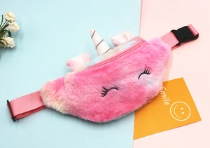 Detail of plush unicorn waist bag with rainbow fur, golden horn and soft strap