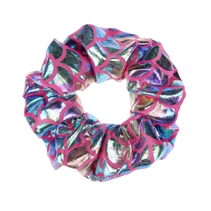 Detail view showing the colorful mermaid scale texture of the fabric scrunchie hair accessory