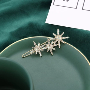 Elegant gold metal hair clip with sparkling star and snowflake crystal rhinestones