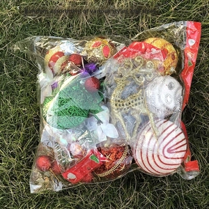 Macro view of assorted Christmas glitter reindeer and baubles in a wholesale package