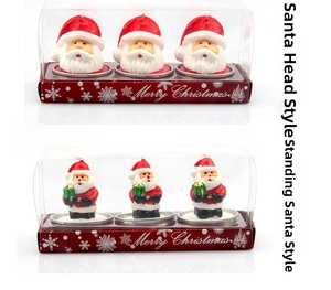 Detail of Christmas candles in Santa Claus shapes within Merry Christmas gift packaging