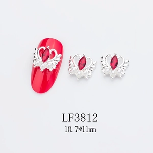 Détail macro de charmes d'ongles cœur en argent avec pierre rouge et perles, 10,7x11mm