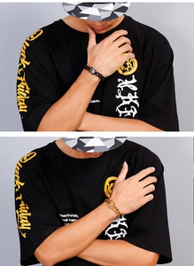 Detail of 18K gold and matte black hip hop cuban link bracelets with paved square clasps