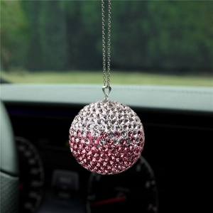 Macro view of crystal ball car pendant with pink rhinestones and silver metal chain