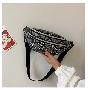 Detail showing dual zipper compartments and snakeskin pattern on women's waist bag