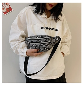 Detail of snake skin print waist bag worn by model with adjustable strap