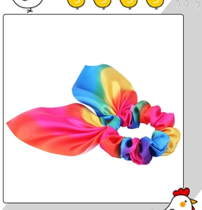Detailed view of rainbow gradient fabric scrunchie with elegant ribbon bow knot