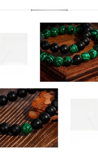 Detail of matte black onyx and malachite beaded bracelet on vintage wooden background