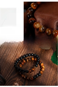 Macro detail of elastic beaded bracelet featuring tiger eye and matte black agate stones