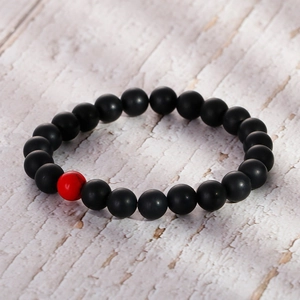 Minimalist 8mm matte black agate beaded bracelet with a single red turquoise stone accent