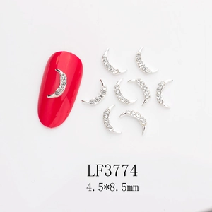 Macro view of moon-shaped silver nail charms with white rhinestones and dimensions