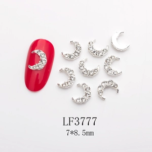 Macro view of moon-shaped silver nail charms with rhinestones, size 7x8.5mm