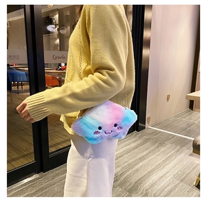 Detail of plush star-shaped crossbody bag with gradient pink and blue fur and gold chain