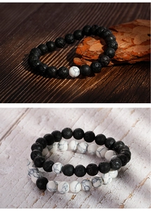 Macro detail of black volcanic lava stones and white marble textured beads bracelet