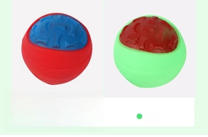 Detailed view of red and green durable dog chew balls with embossed bone texture