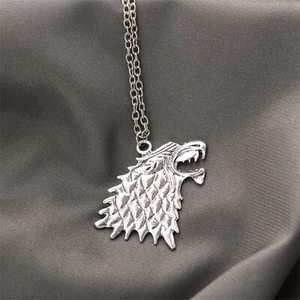 Macro view of vintage silver wolf head brooch with detailed textures for men suit