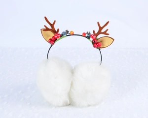 Detailed view of white fluffy earmuffs with reindeer antlers and festive Christmas decor